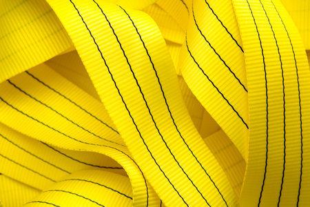 Industrial sewing machine sews a webbing sling. Manufacture of textile slings and tie strapsの写真素材