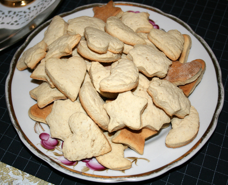 Ginger biscuits on a white plate with pink flowersの写真素材