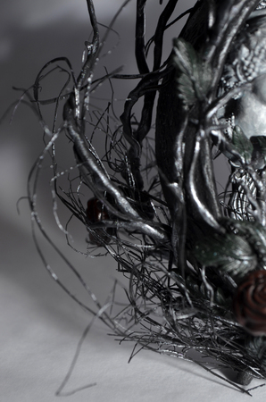 Closeup of handmade photoframe made of old clock, view on thorn and rose bushの写真素材