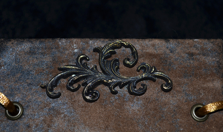 Closeup of a decorative element on an old-looking handmade notebookの写真素材