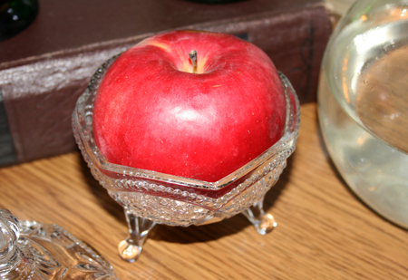Big red apple in a crystal bowlの写真素材