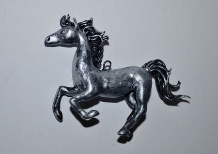 Small pendant in the form of silver hourseの写真素材