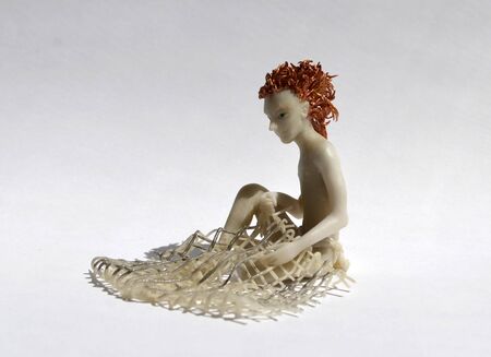 Copper-haired boy weaves a net, right side viewの写真素材