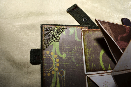 Closeup of a decorative element inside handmade vintage-looking photoalbumの写真素材