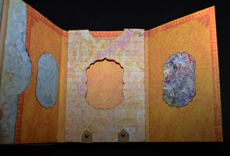 Hidden page on a first spread of a small old-looking photoalbumの写真素材