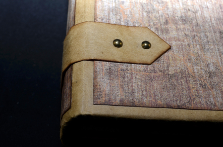 Closeup of a closing element on a cover of a handmade ancient-looking photoalbumの写真素材