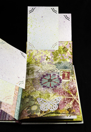 Hidden page on a fourth spread of small handmade photoalbumの写真素材