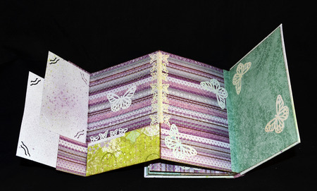 Hidden page on the last spread of a small handmade photoalbumの写真素材