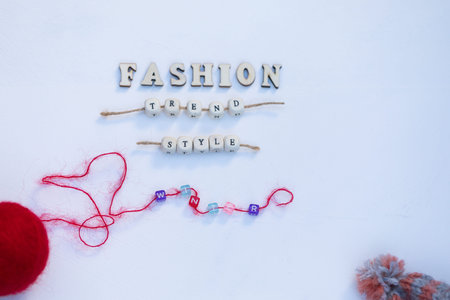 Fashion Winter Cozy Mood Concept. Red Ball of Wool, Warm Hat with Pompom and Words Fashion Trend...
