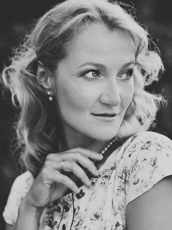 Beautiful woman in a vintage dress, stylized BW shot, 50s-60sの写真素材