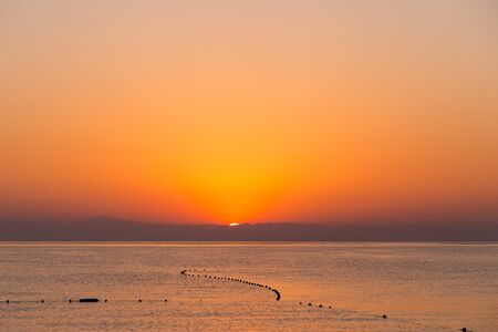 Beautiful golden sunrise over the horizon on the Mediterranean Sea in Turkey, Kemerの写真素材