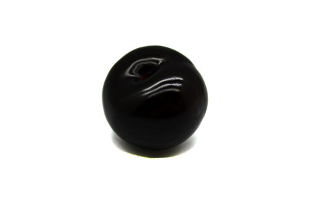 Black plum berry close up isolated on a white background