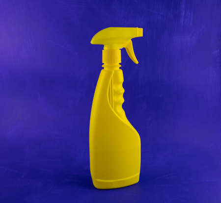 Yellow cleaning agent container on a blue backgroundの写真素材