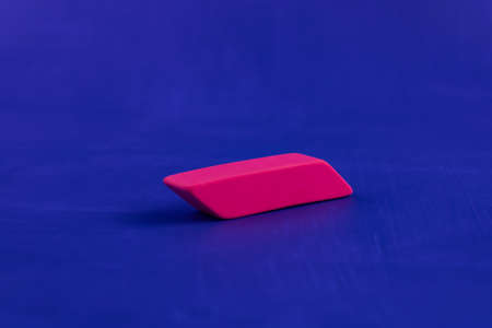 Pink eraser close-up on a blue backgroundの写真素材