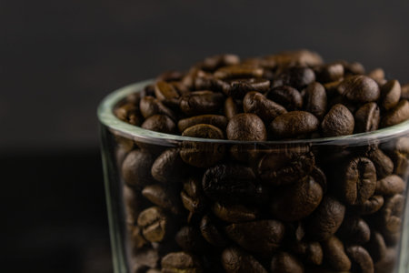 Transparent Cup with coffee beans close up