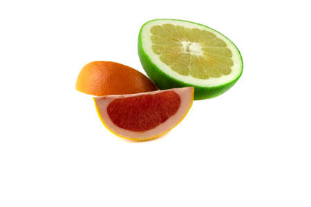 Half a juicy lime and two slices of grapefruit in close-up, isolated on a white background.の写真素材