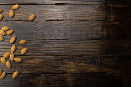 Mature almonds close-up on a dark wooden background. Top view, copy space.の写真素材
