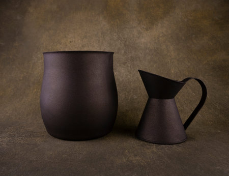old vase and jug close-up on dark backgroundの写真素材