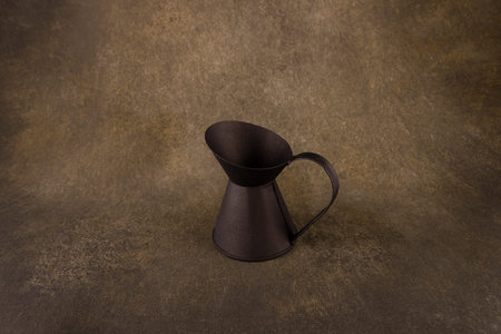 old small jug close-up on dark background close-up on dark backgroundの写真素材