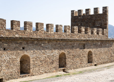 the ancient fence of the fortress, the ruins of the castle built of ancient stoneの写真素材