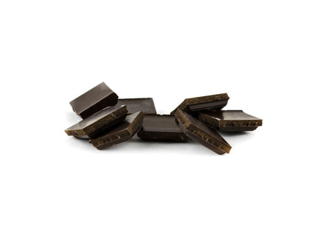 small randomly broken dark chocolate bars isolate