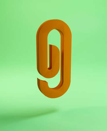 Orange paper clip on a green background, 3d illustration.の写真素材