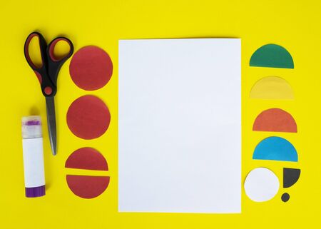 Step by step childrens cardboard crafts - colored parrot on a white paper sheet. Scissors, glue, paper sheets. Set for kids art. Children activity in kindergarten, school, at home. Step 1の写真素材