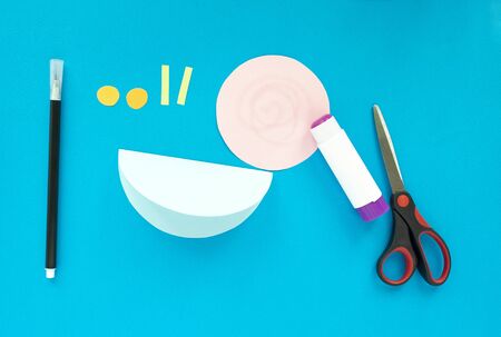 Step by step children's cardboard crafts - colored swinging snail. Scissors, glue, paper sheets. Set for kids art. Children activity in kindergarten, school, at home. Step 4.の写真素材