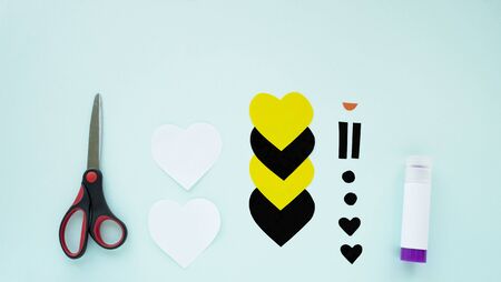 Step by step childrens cardboard crafts - colored bee . Scissors, glue, paper sheets. Set for kids art. Children activity in kindergarten, school, at home. Step 3の写真素材