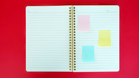 Open blank journal on red background. Concept for creative person planning. Back to school. Top...