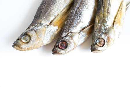 isolated close up top view three dried salted chehon fish on a white backgroundの写真素材