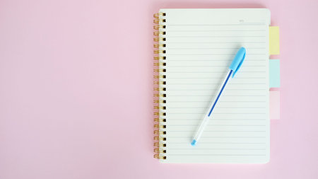Open blank journal on pink background. Concept for creative person planning. Back to school. Top...