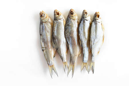 isolated close up top view dried salted caspian roach fish on a white backgroundの写真素材