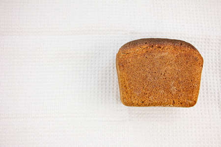 Homemade rye sourdough bread with a crisp crust on moneycomb towel background. Copy spaceの写真素材