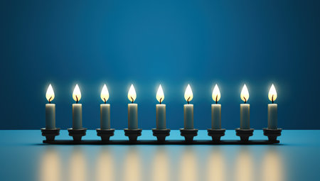 A row of lit candles against a blue background, creating a serene and festive atmosphereの素材
