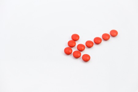 red round pills on a white backgroundの写真素材
