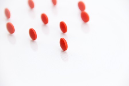 red round pills on white backgroundの写真素材