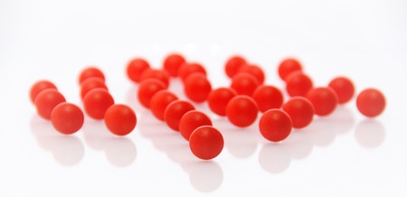 red round pills on white backgroundの写真素材