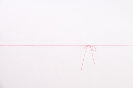 red thread on white backgroundの写真素材