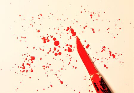 red paint splattered on white paperの写真素材