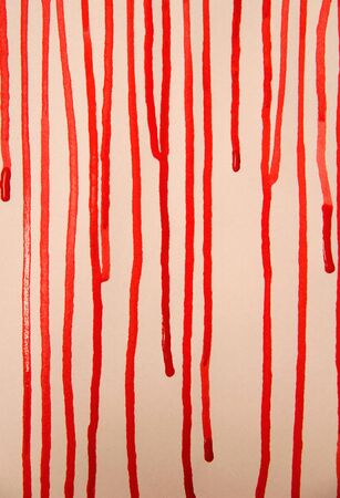 red paint splattered on white paperの写真素材