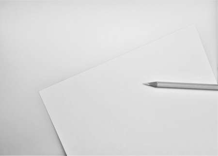 yellow pencil on white paperの写真素材