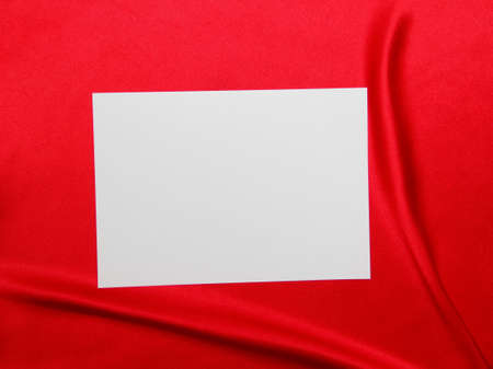 a blank sheet of paper on a red tableclothの写真素材