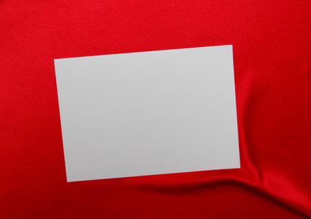 a blank sheet of paper on a red tableclothの写真素材