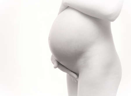 naked pregnant girl on a white backgroundの写真素材