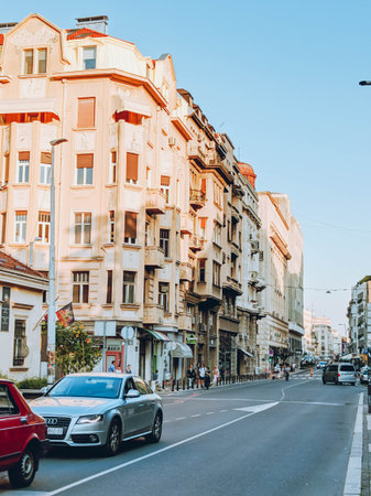 Urban street scene in the center of Belgrade. Warm evening light, European architecture, vintage colors and subtle film grain atmosphereの写真素材