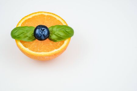 orange fruit with mint and blueberry on white backgraundの写真素材