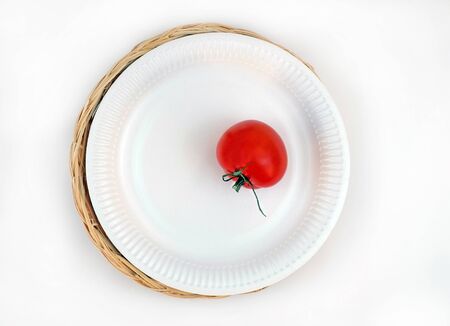 Paper cardboard dishes with tomato and wooden plate on white background. Ecology concept.の写真素材