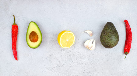 Ingredients for mexican sauce guacamole on grey background