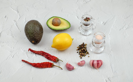 Ingredients for mexican sauce guacamole on textured backround, colorful